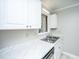 Bright kitchen sink area with white cabinets, modern countertops, and stainless steel sink at 235 Pine Shadow Dr, Goose Creek, SC 29445