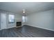 Bright living room with a cozy fireplace, ceiling fan, and sleek gray laminate flooring at 235 Pine Shadow Dr, Goose Creek, SC 29445