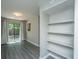 Living room with storage nook, sliding glass door with curtains, and views of the backyard at 235 Pine Shadow Dr, Goose Creek, SC 29445