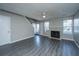 Open living space with fireplace, ceiling fan, gray laminate flooring and entrance at 235 Pine Shadow Dr, Goose Creek, SC 29445