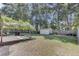A large, shaded backyard features a patio and mature trees, offering the perfect blend of relaxation and entertainment space at 25 Aldene Ave, Goose Creek, SC 29445