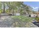 A spacious backyard with a storage shed and patio offers a serene outdoor living space for relaxation and entertaining at 25 Aldene Ave, Goose Creek, SC 29445
