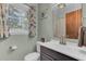 Bathroom featuring a modern vanity, brushed gold faucet, and leafy green walls at 25 Aldene Ave, Goose Creek, SC 29445