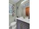 Bathroom featuring a modern vanity, brushed gold faucet, and leafy green walls at 25 Aldene Ave, Goose Creek, SC 29445