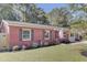 Charming single-story brick home with a well-manicured lawn and an American flag at 25 Aldene Ave, Goose Creek, SC 29445