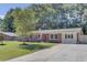 Charming single-story brick home with a well-manicured lawn and a long driveway at 25 Aldene Ave, Goose Creek, SC 29445