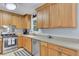 Well-equipped kitchen with natural wood cabinets, stainless steel appliances, and a functional layout for cooking at 25 Aldene Ave, Goose Creek, SC 29445