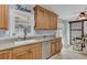 Charming kitchen with updated appliances and wood cabinetry and a dining area with a modern sliding barn door at 25 Aldene Ave, Goose Creek, SC 29445