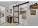 Convenient laundry room featuring a sliding barn door for access and shelving for storage at 25 Aldene Ave, Goose Creek, SC 29445