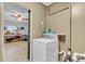 Functional laundry room with a modern washing machine and practical shelving for storage and cleaning supplies at 25 Aldene Ave, Goose Creek, SC 29445