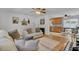Comfortable living room featuring a plush sofa, hardwood floors, and an open layout connected to the dining area at 25 Aldene Ave, Goose Creek, SC 29445