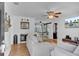 Bright living room featuring hardwood floors, ceiling fan, and backyard access through sliding barn doors at 25 Aldene Ave, Goose Creek, SC 29445