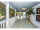 Spacious back porch perfect for relaxation with ample seating and a ceiling fan at 2613 Rivertowne Pkwy, Mount Pleasant, SC 29466