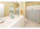 Bright bathroom features a double sink vanity, tile floor, and tub/shower combo with nautical-themed curtain at 2613 Rivertowne Pkwy, Mount Pleasant, SC 29466