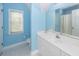 Clean and well-lit bathroom with a vanity, toilet, and blue painted walls at 2613 Rivertowne Pkwy, Mount Pleasant, SC 29466