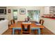 Dining room featuring a wooden table set with a view to a screened porch and fireplace at 2613 Rivertowne Pkwy, Mount Pleasant, SC 29466