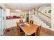 Dining area with hardwood floors adjacent to the kitchen and stairs at 2613 Rivertowne Pkwy, Mount Pleasant, SC 29466