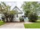 Two-story home with white siding and trees, surrounded by green grass at 2613 Rivertowne Pkwy, Mount Pleasant, SC 29466