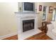 Close up of a cozy fireplace with white mantel, tile details and mounted tv at 2613 Rivertowne Pkwy, Mount Pleasant, SC 29466