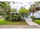 Charming two-story home with a front porch, lush landscaping, and a welcoming entrance at 2613 Rivertowne Pkwy, Mount Pleasant, SC 29466