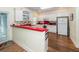Bright kitchen with white cabinets, red countertops, and hardwood floors at 2613 Rivertowne Pkwy, Mount Pleasant, SC 29466