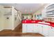 Open kitchen layout with white cabinets and red countertops leading to living area at 2613 Rivertowne Pkwy, Mount Pleasant, SC 29466