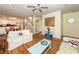 Cozy living room with hardwood floors, a ceiling fan, and staircase at 2613 Rivertowne Pkwy, Mount Pleasant, SC 29466