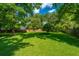 Spacious backyard featuring a lawn with mature trees, offering privacy at 2650 Summer Leaves Ct, Charleston, SC 29414