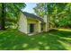 Large backyard featuring mature trees and a well-maintained lawn at 2650 Summer Leaves Ct, Charleston, SC 29414
