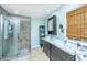Bathroom with double vanities, tiled shower, and view of the window at 2650 Summer Leaves Ct, Charleston, SC 29414