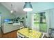 Bright dining area featuring hardwood floors, a fireplace, and sliding door access to the backyard at 2650 Summer Leaves Ct, Charleston, SC 29414