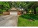 Traditional-style brick home with an attached two-car garage and a green, tree-lined yard at 2650 Summer Leaves Ct, Charleston, SC 29414