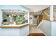Spacious kitchen and staircase featuring hardwood floors, bright cabinets, and an open breakfast bar at 2650 Summer Leaves Ct, Charleston, SC 29414