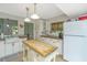 Bright kitchen featuring an island, farmhouse sink, and butcher block countertops at 2650 Summer Leaves Ct, Charleston, SC 29414