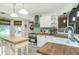Bright kitchen with hardwood floors, an island, white cabinets, and stainless steel appliances at 2650 Summer Leaves Ct, Charleston, SC 29414