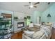 Cozy living room featuring a brick fireplace, hardwood floors, and lots of natural light at 2650 Summer Leaves Ct, Charleston, SC 29414