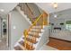 A view of a staircase with wood and beige walls leading to the living room at 2650 Summer Leaves Ct, Charleston, SC 29414