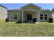 Well-maintained backyard featuring a covered patio, outdoor furniture, and a barbecue grill at 305 Camellia Bloom Dr, Moncks Corner, SC 29461