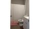 Clean bathroom with white shower curtain, toilet, vanity, and pink floor mat at 305 Camellia Bloom Dr, Moncks Corner, SC 29461