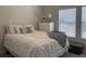 Well-lit bedroom with a white bed, decorative pillows, and a window view at 305 Camellia Bloom Dr, Moncks Corner, SC 29461