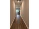 Long hallway with wood floors leads to dining area with natural light at 305 Camellia Bloom Dr, Moncks Corner, SC 29461