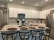 Bright kitchen features a large island with seating and modern appliances at 305 Camellia Bloom Dr, Moncks Corner, SC 29461