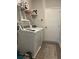 Functional laundry room with washer, dryer, storage shelving, and ceramic tile flooring at 305 Camellia Bloom Dr, Moncks Corner, SC 29461