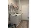 Functional laundry room with washer, dryer, storage shelving, and ceramic tile flooring at 305 Camellia Bloom Dr, Moncks Corner, SC 29461