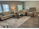 Bright living room with plush seating, large rug, and a coffee table creates a warm gathering space at 305 Camellia Bloom Dr, Moncks Corner, SC 29461