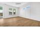 Light and airy bedroom features paneled walls, hardwood flooring, and large windows at 305 Matilda St, Edisto Beach, SC 29438