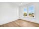Well-lit bedroom with hardwood floors and bright white trim and walls at 305 Matilda St, Edisto Beach, SC 29438