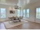 Spacious dining area with a long table, seating, recessed lights, and exterior views at 305 Matilda St, Edisto Beach, SC 29438