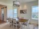 Elegant dining room featuring a large table, seating for six, modern lighting, and plenty of light at 305 Matilda St, Edisto Beach, SC 29438