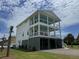 Impressive multi-story beach home with spacious balconies and a welcoming facade at 305 Matilda St, Edisto Beach, SC 29438